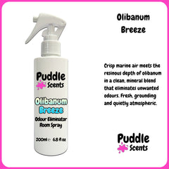 Olibanum Breeze odour eliminator room spray bottle with branding and product description on a white background.